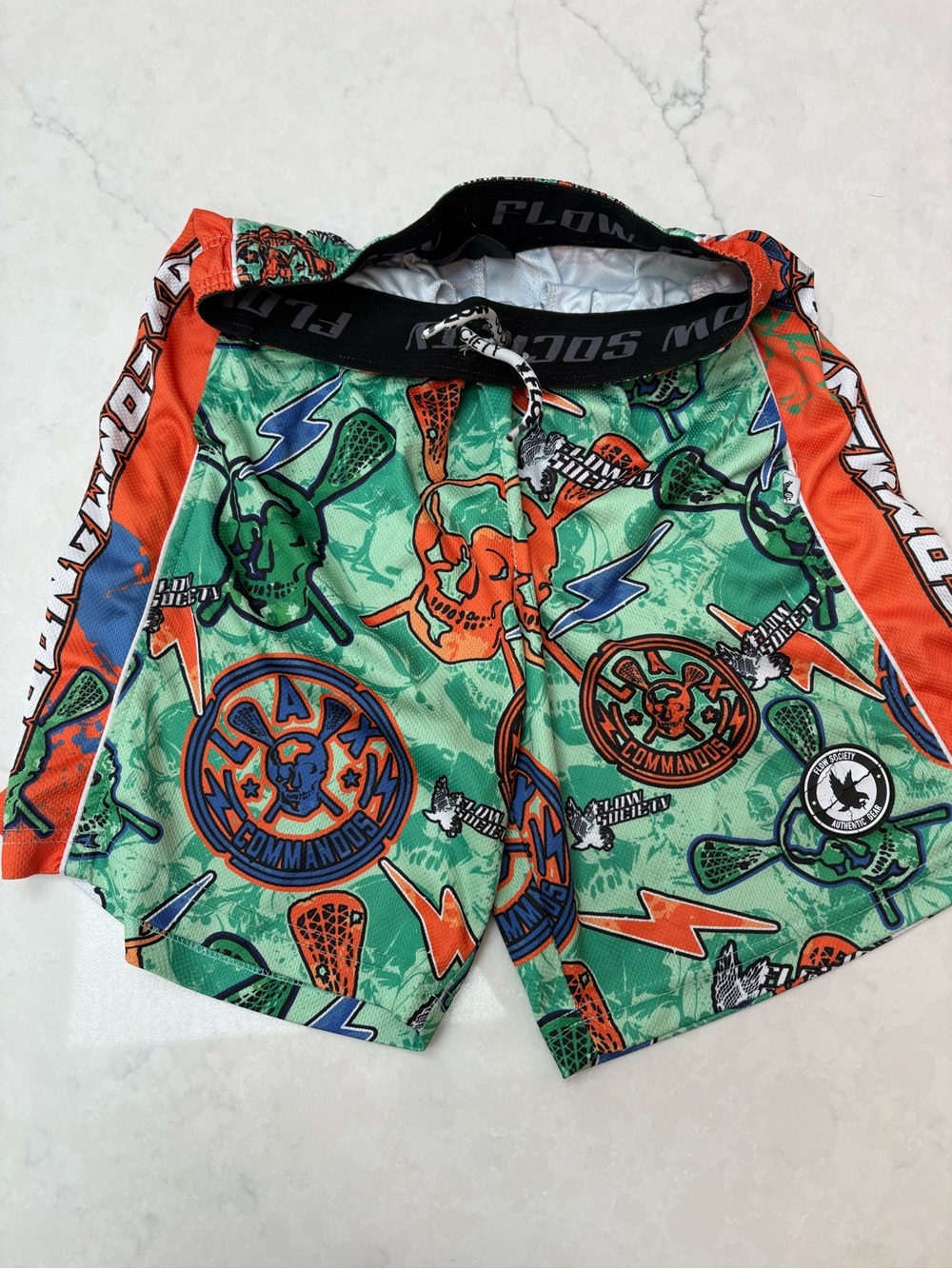 Flow Society Lacrosse Graphic Athletic Shorts in Green and Orange